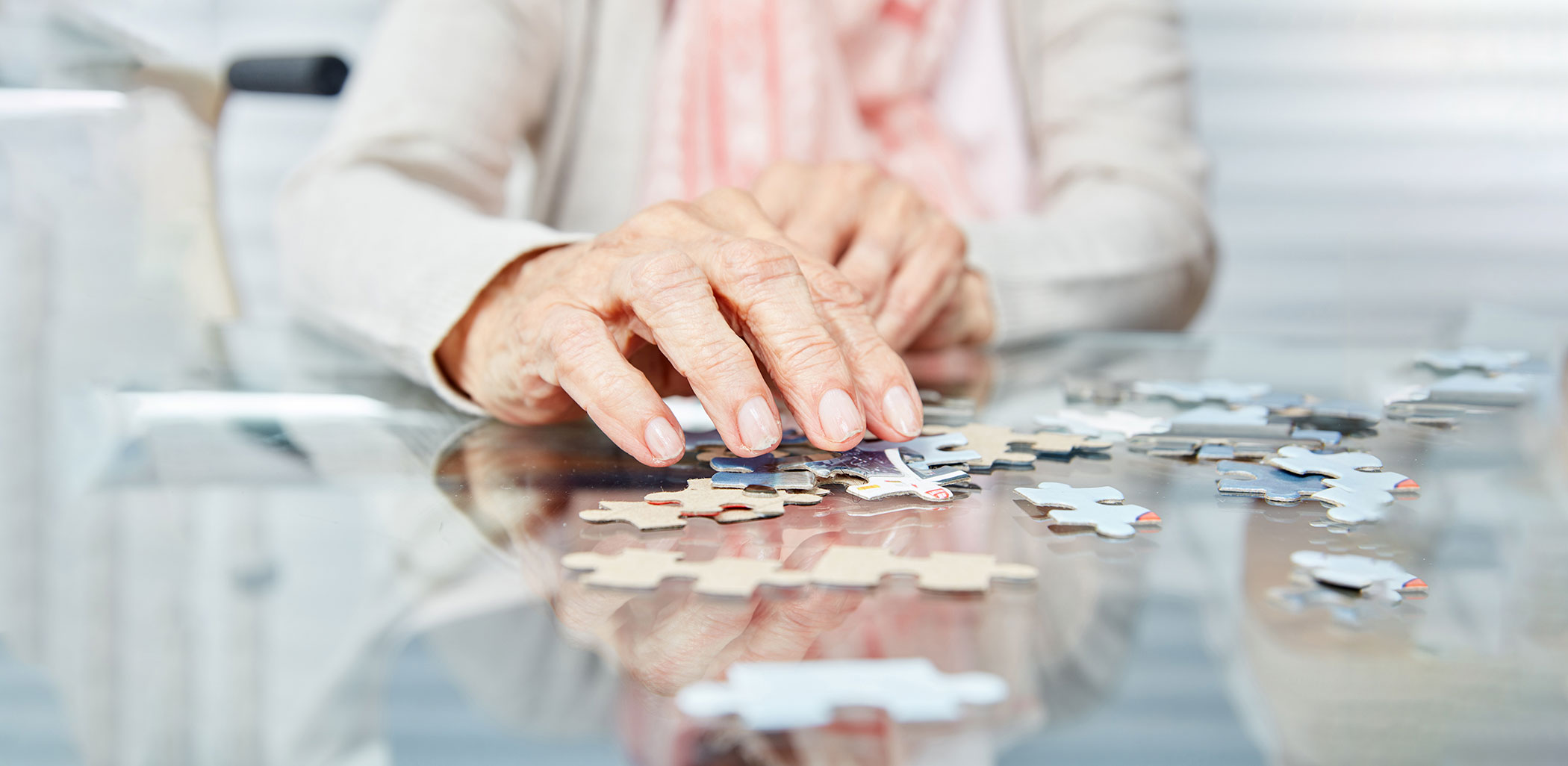 memory care hands with puzzle