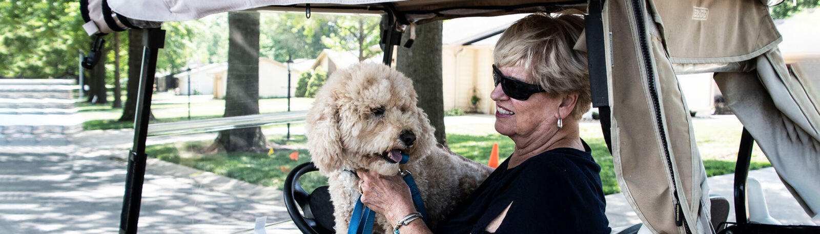 Testimonials - woman with dog in golf card